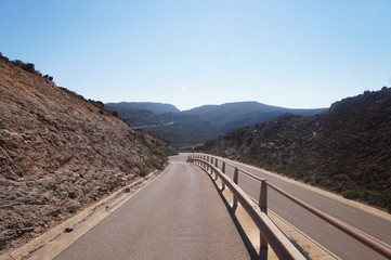 Empty clean smooth highway road close up on a sunny summer tropical island near the mountains and the sea for background.