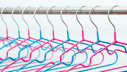 Empty hangers on a white background. The concept of nothing to wear, no clothes. It's time for shopping. Multicolored bright hangers fashionable colors. Fashion style and discounts.