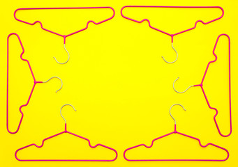 Empty hangers on yellow background . The concept of nothing to wear, no clothes. It's time for shopping. Multicolored bright hangers fashionable colors. Fashion style and discounts. wardrobe. flat lay