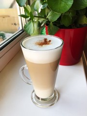 Delicious coffee latte with cinnamon on the windowsill