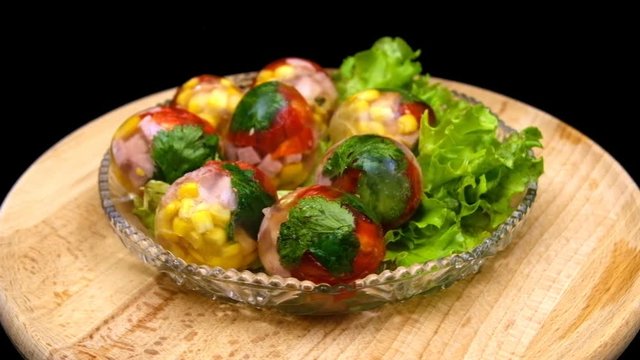 Faberge flooded eggs rotate in front of the camera on a wooden stand