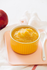 Homemade healthy baby food. Bowl of apple baby puree.