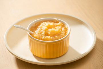 Natural baby food concept. Bowl of apple baby puree.
