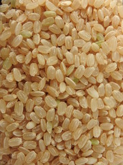 Top view of brown rice (also called hulled rice, unpolished rice,husked rice).   Nutrition rich in protein, lipids, fiber, vitamin B1. Asian, Chinese food background. Health, agriculture concept.