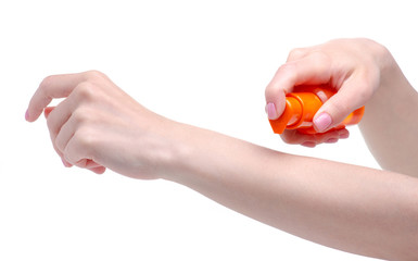 Orange sunscreen suntan bottle in hand on a white background. Isolation