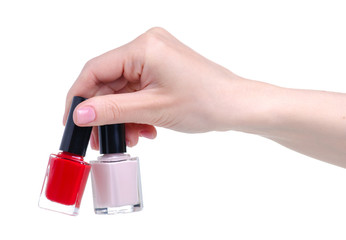 Different color nail polish in hand on a white background. Isolation