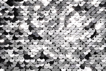 Sequin fabric background. Close-up shot of glittery black sequins texture