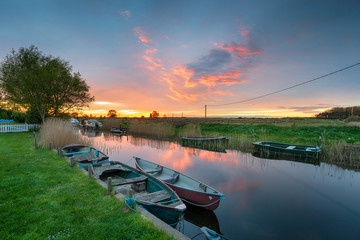 Stunning sunset over boats moored on the river at West Somerton