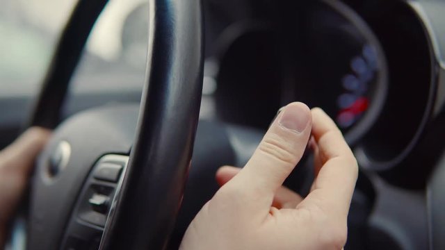 Car driver pusing lever in a car.