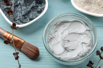 Cosmetic clay. clay facial mask on a gentle blue background. different types of clay. natural...