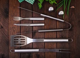 Barbecue Tools on wooden table. Flat lay, top view