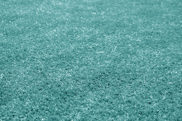 Artificial grass football field loan with blur effect in cyan tone.