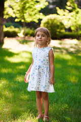 Llittle girl child outdoor in summer day.