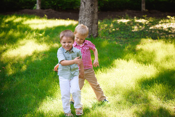 Fototapeta premium Two young boys walk and relax in the park.