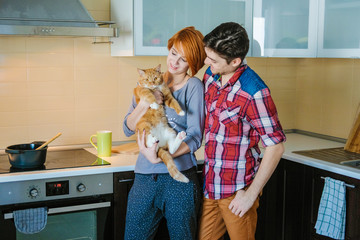 A young couple prepares dinner in a modern kitchen.