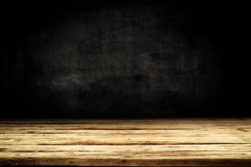 Dark desk background of free space for your decoration and black wall space 