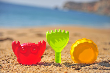 Set of colorful toys on sand beach