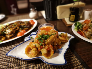 Three oriental dishes with beef, shrimps, tomatoes, carrots, red pepper and rice noodles. Asian, Thai, Chinese cuisine.