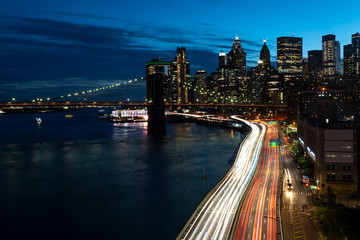 Fototapeta na wymiar Long exposure of the Lower Manhattan skyline with traffic at blue hour from elevated vantage point