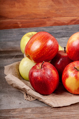Fototapeta na wymiar A lot of apples on a wooden table