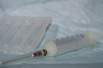 medical syringe with a needle on the background of drugs