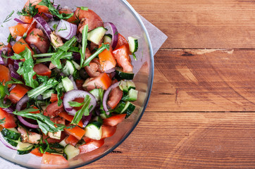 Fresh fragrant salad with tomatoes, cucumbers, onions, parsley, dill and lettuce leaves. Vegetarian...
