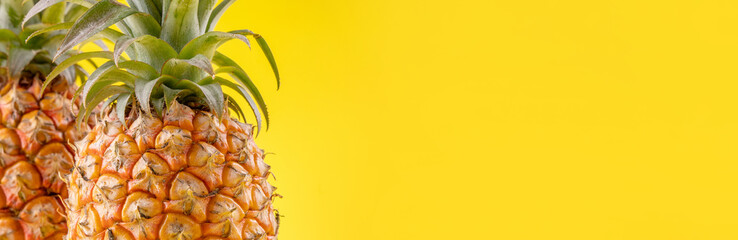 Beautiful fresh pineapple isolated on bright yellow background, summer seasonal fruit design idea pattern concept, copy space, close up