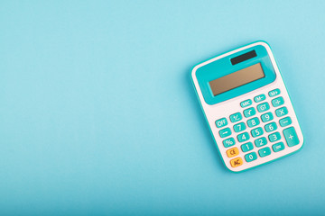 close-up and selective focus shot, calculator on blue background. copy space for text - obrazy, fototapety, plakaty