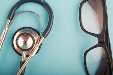 Healthcare and medical concept, stethoscope and spectacles on blue background.copy space for text