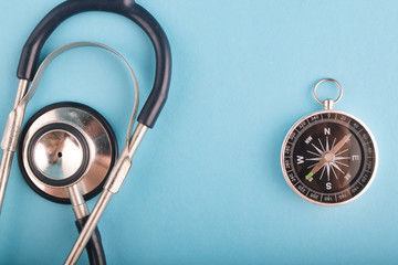 Healthcare and medical concept, stethoscope and compass on blue background.copy space for text
