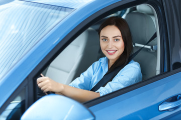 Found the perfect car. Beautiful cheerful woman smiling happily while sitting in her car