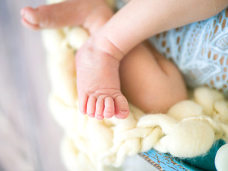 Small legs of a newborn baby close up