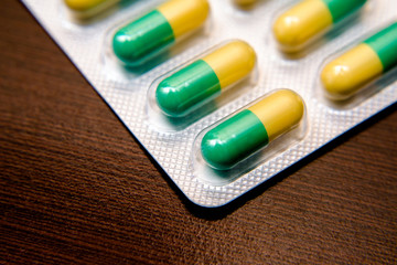 Packaging with pills is on a brown background 