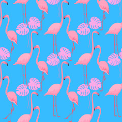 A couple of graceful flamingos. Monster leaves. Tropical summer background. Seamless pattern