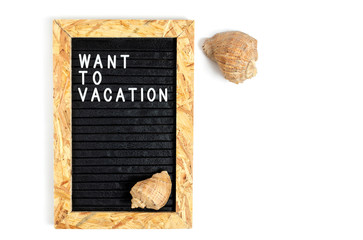 Letter board with the inscription want to vacation on a white background.Shells and shells.