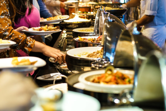 Hand of people take buffet food in hotel party