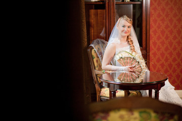 Wedding concept. Happy bride in fashionable dress indoors smiling with stylish hairstyle