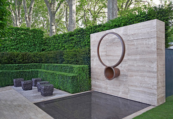 A classical garden with an avenue of yew, box and hornbeam leading to a water feature and sculpture