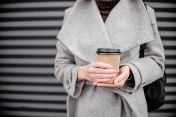 Woman female hand with coffee cup paper latte.