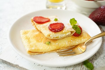 Homemade sweet Crepes with ricotta filling / Thin pancakes with cheese stuffing