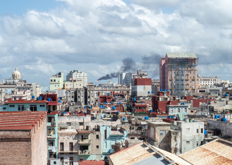 View over the rooftops of Havana, Cuba with oil refinery in distance