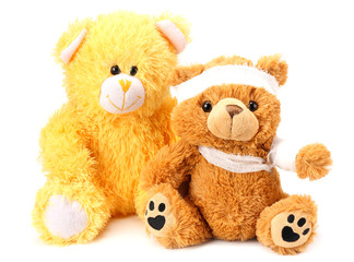 Two toy teddy bears with bandage isolated on white background