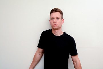 Man looking directly into camera, model not smiling and facing forwards
