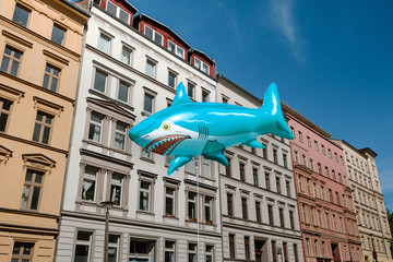 Shark ballon with real estate building facade background