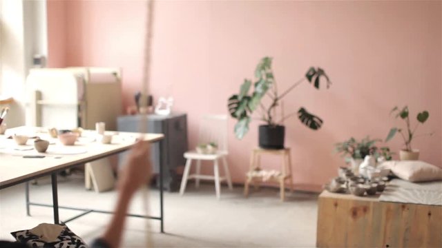  young woman backs swinging on a swing in a studio workshop