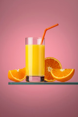 Glass of fresh orange juice with fresh fruits.