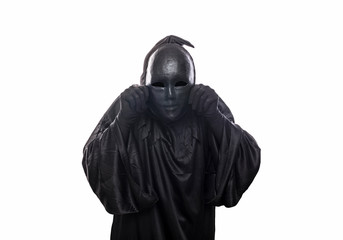 Scary figure in hooded cloak with mask in hand isolated on white background