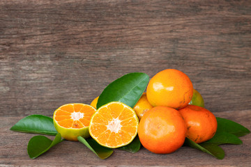 Ripe oranges and leaves on a wooden table, separate on the old wooden floor, sour fruit