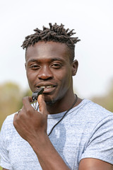 England, UK, circa 2019. Portrait of a referee or coach about to blow a black whistle.