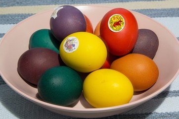 Painted eggs on a plate and a cake